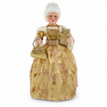 A vintage-style collectible doll dressed in an ornate gold gown with sequins, white fur trim, and a white powdered wig, holding a matching gold handbag and wrapped presents against a plain white background.