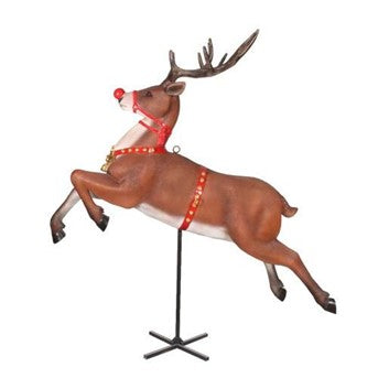 A brown reindeer Christmas decoration shown in a leaping pose on a black stand against a plain white background. The reindeer has antlers, a red nose, and a red harness with gold accents.