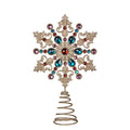 An ornate snowflake-shaped tree topper with a spiral metal stake, featuring a gold-toned filigree design adorned with blue, purple, red, and orange faux jewels, shown on a plain white background.