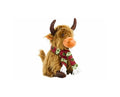 A plush Highland cow toy with shaggy brown fur, dark brown horns, and an orange snout, wearing a red knit scarf with green and white floral patterns and white tassels, isolated on a white background.