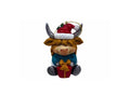 A Highland cow Christmas ornament wearing a red Santa hat, blue outfit, and holding a red gift box with a gold bow, set against a plain white background.