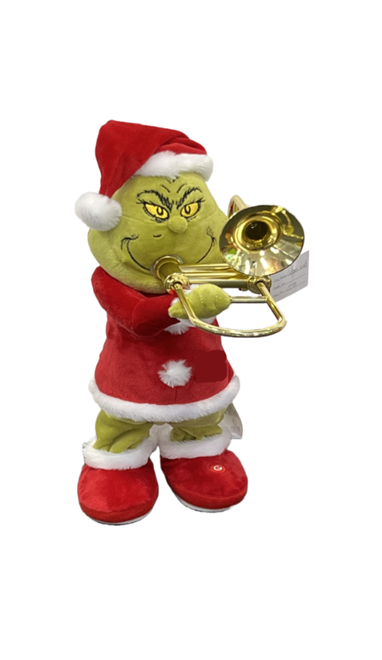 Grinch plush toy wearing a red Santa hat and Santa suit with white trim, holding a gold brass trumpet against a plain white background.